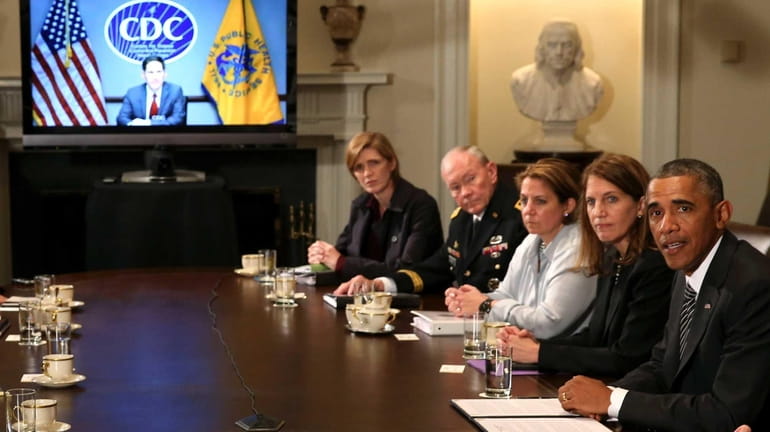 President Barack Obama speaks with members of his cabinet about...