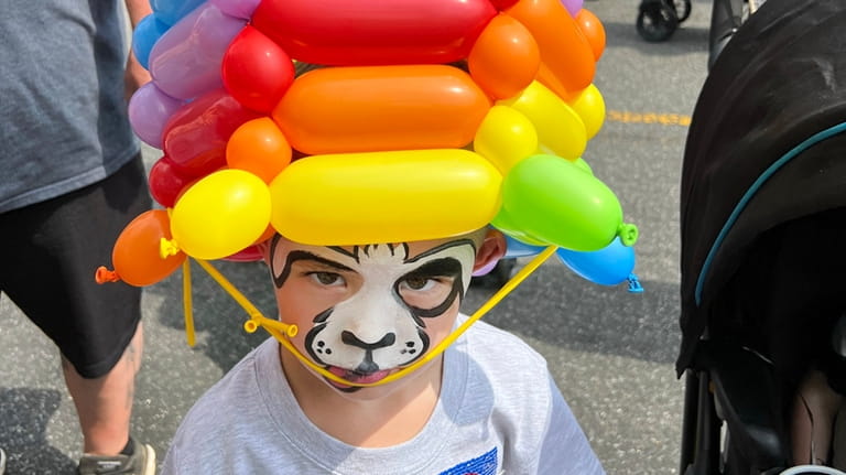 Damian Jackson, of Mastic Beach, gets a multi-colored balloon hat...