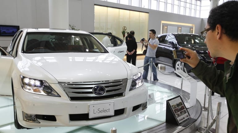 A Lexus LS650hL sits in a Tokyo showroom Wednesday. Toyota...
