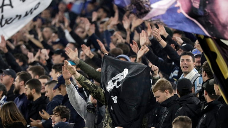 A group of Lazio fans make the fascist salute ahead...