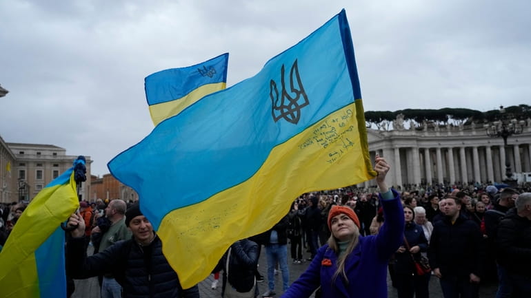People waves Ukrainian flags before Pope Francis Angelus noon prayer...
