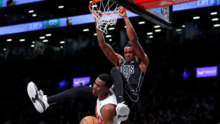 Brooklyn Nets forward Nic Claxton (33) dunks over Toronto Raptors...