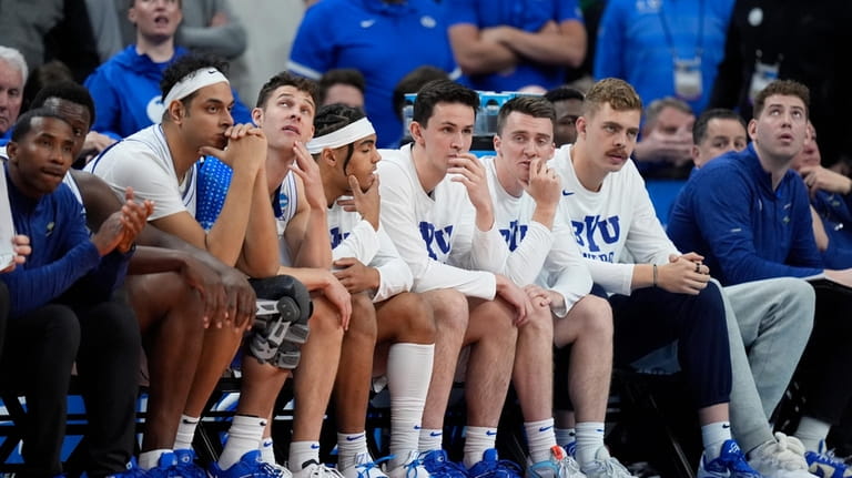 The BYU bench watches in the final minute of the...