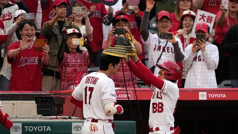 Los Angeles Angels' Shohei Ohtani, left, is given a Kabuto...