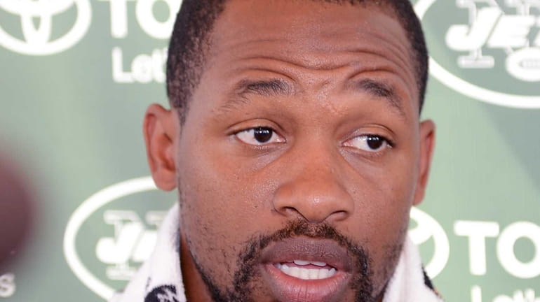 Jets cornerback Dimitri Patterson talks with reporters during NFL training...