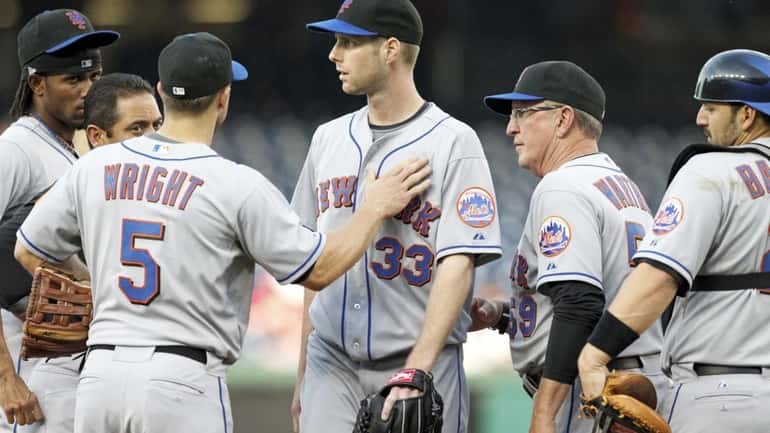 New York Mets starting pitcher John Maine leaves the game...