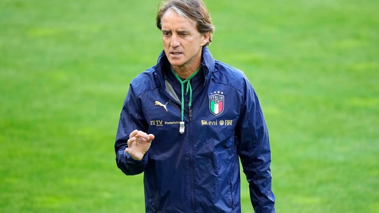 FILE - Italy's head coach Roberto Mancini talks to his...