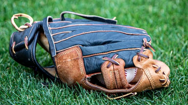 A glove and ball are seen during Yankees spring training in...