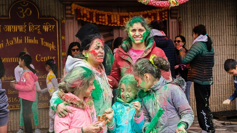 Hindu worshippers celebrate Holi, the festival of colors, outside the...
