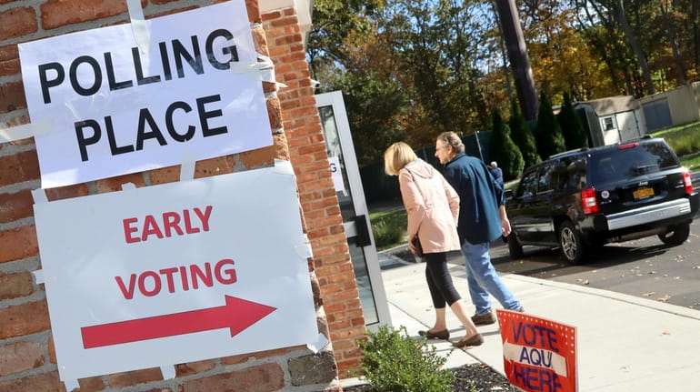 Voters arrive for the first day of early voting at...