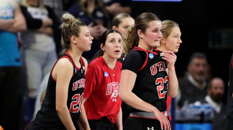 Utah players walk to a timeout late in a second-round...