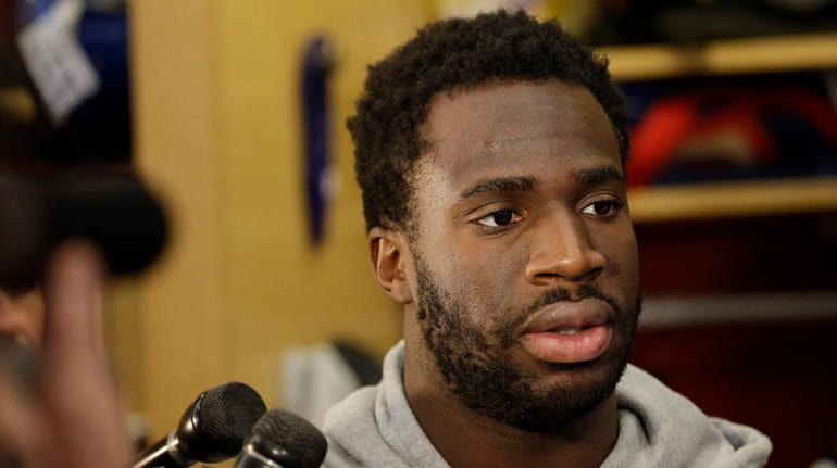 The New York Giants' Prince Amukamara talks to reporters in...