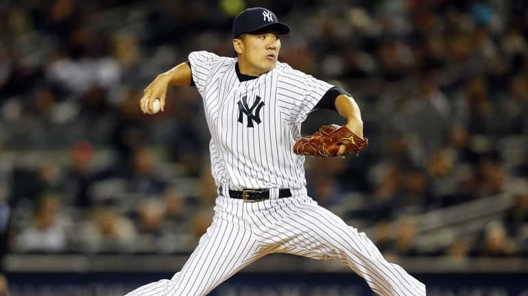 Masahiro Tanaka pitches in the first inning against the Los...