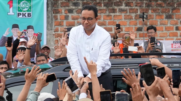 Presidential candidate Anies Baswedan greets supporters during his campaign rally...