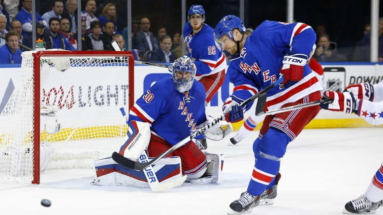 Henrik Lundqvist #30 and Kevin Klein #8 of the New...