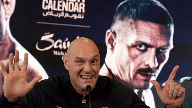 British professional boxer Tyson Fury gestures during a news conference...