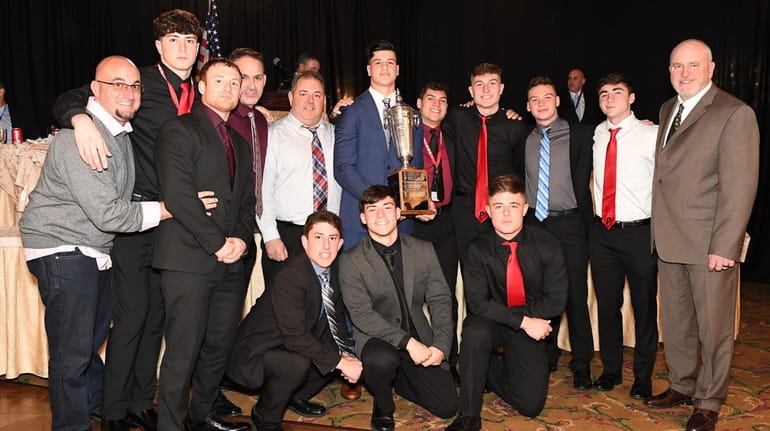 Plainedge football players and coaches pose with their Rutgers Cup at...