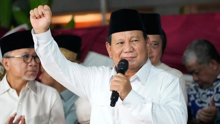 Indonesia's Defense Minister Prabowo Subianto raises his fist as he...
