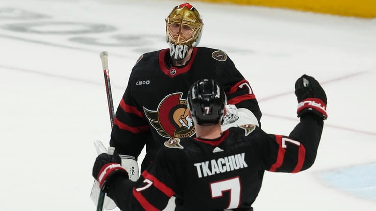 Ottawa Senators left wing Brady Tkachuk (7) races to congratulate...