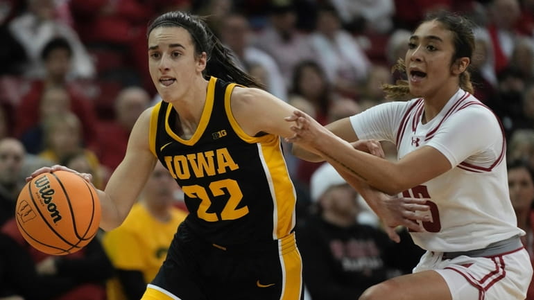 Iowa's Caitlin Clark drives past Wisconsin's Sania Copeland during the...