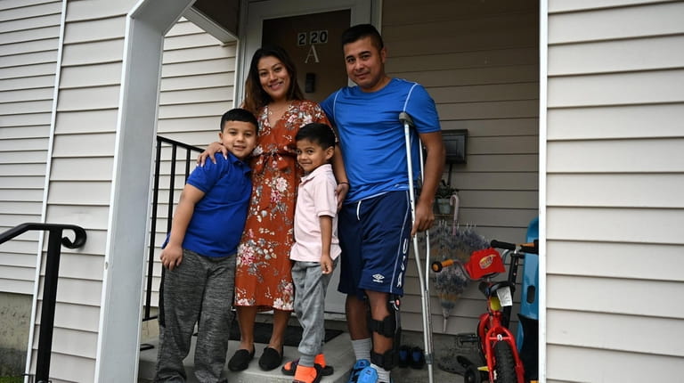 Jessica and Erick Mendez with sons James, 8, left, and Erick,...
