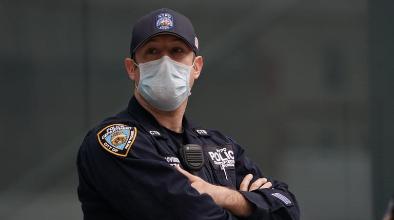 A member of the NYPD wears a mask while working...