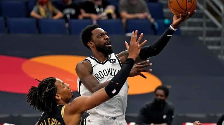 Nets forward Jeff Green (8) goes for a layup over...