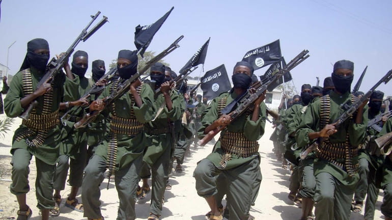 al-Shabab fighters march with their weapons during military exercises on...