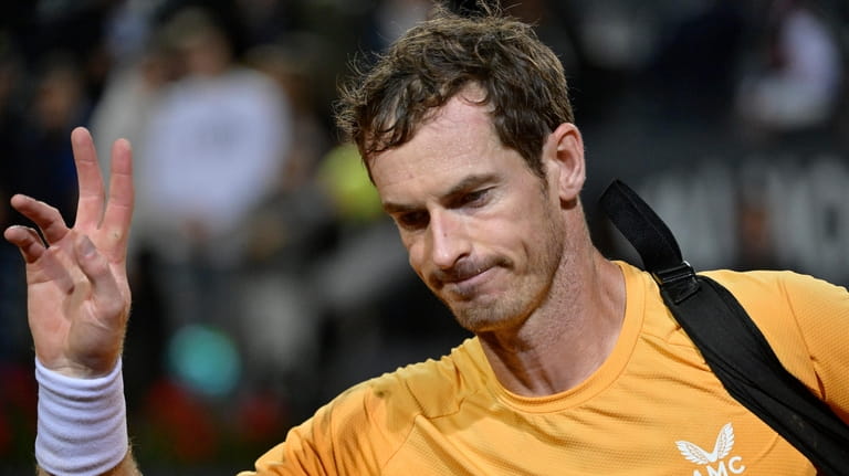 Britain's Andy Murray leaves after he lost his match against...