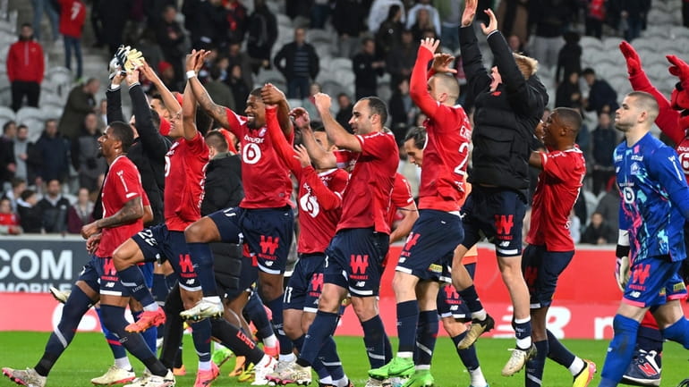 Lille players celebrate their victory at the French League One...