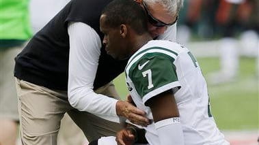 Rex Ryan talks to Geno Smith before a game against...