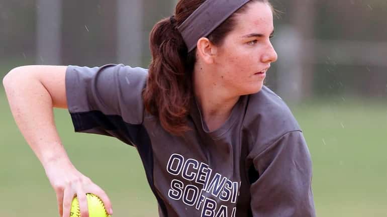 Oceanside softball player Claire McNamara throws the ball during practice...