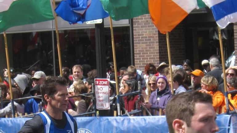 Alex Schneider, right, of Great Neck, crossed the Boston Marathon...