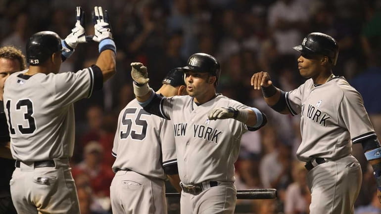Nick Swisher of the New York Yankees celebrates his three-run...