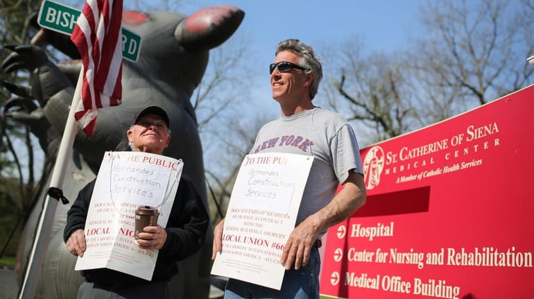 Union members picket over hiring practices outside Siena Village in...