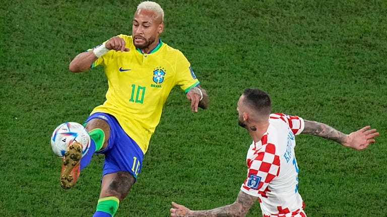 Brazil's Neymar, left, duels for the ball with Croatia's Marcelo...