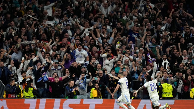 Real Madrid's Karim Benzema, left, celebrates his side's third goal...