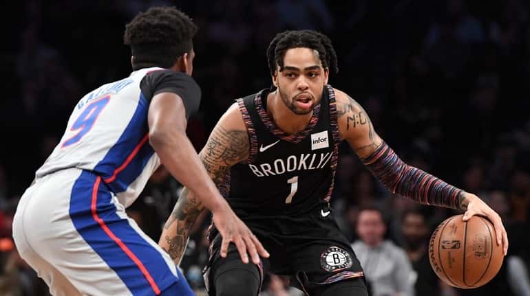 Nets guard D'Angelo Russell controls the ball against Pistons guard...