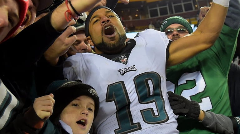 Golden Tate of the Eagles celebrates with fans after beating...