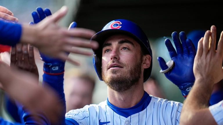 Chicago Cubs' Cody Bellinger celebrates after hitting a home run...