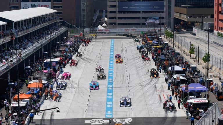 Cars leave the split pit lanes during qualifications for the...