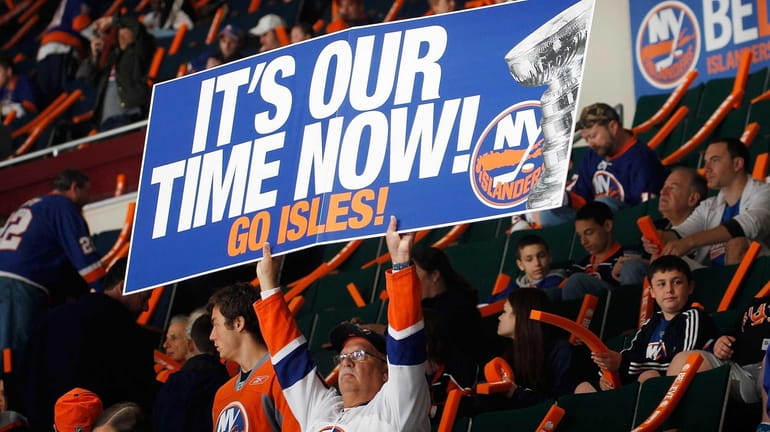 An Islanders fan holds a sign during warm ups before...