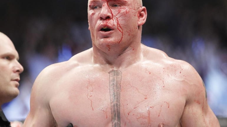 Brock Lesnar walks to his corner at the end of...
