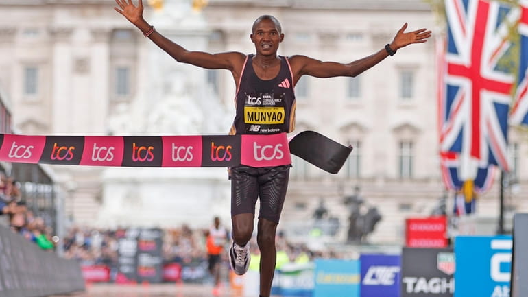 Alexander Mutiso Munyao of Kenya crosses the finish line to...