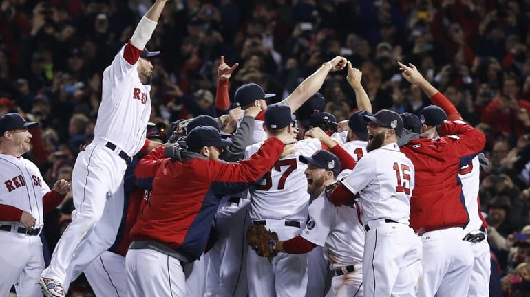 Boston Red Sox players celebrate after defeating the St. Louis...