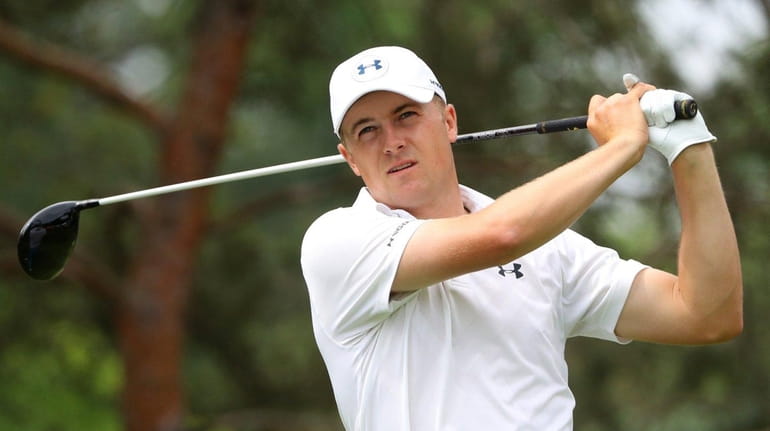 Jordan Spieth watches his tee shot on the second hole...