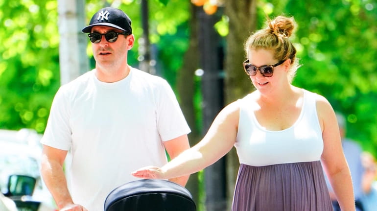 Chris Fischer and wife Amy Schumer take their son, Gene,...