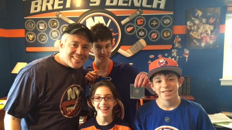 Jeff Siegel, 46, with his kids at an Islanders game.