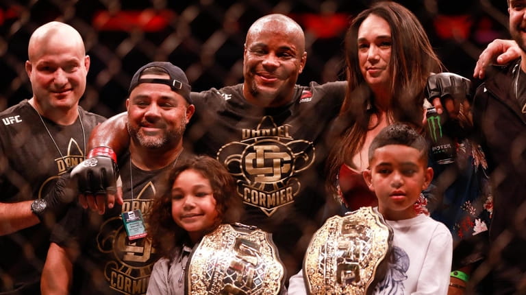 UFC two-weight champion Daniel Cormier with his family and team...