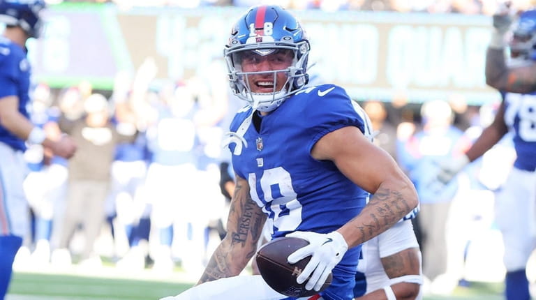 Isaiah Hodgins of the Giants celebrates a first-half touchdown catch against...